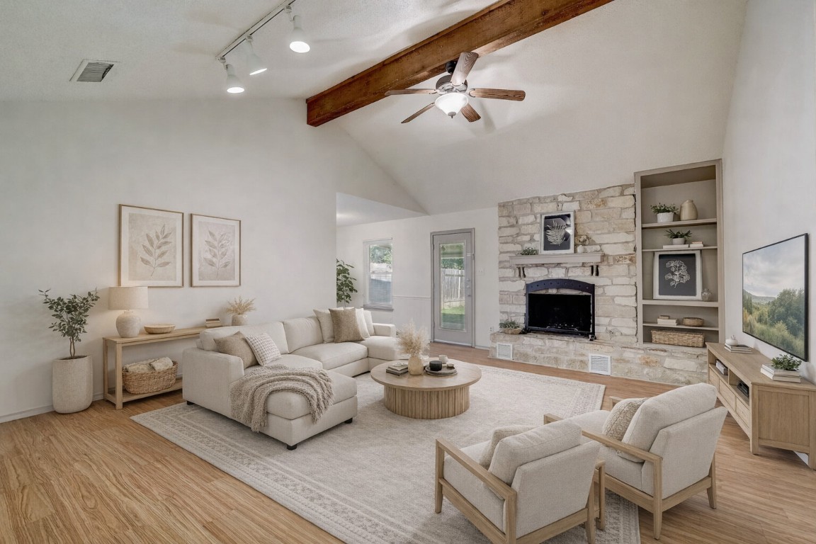a living room with furniture a fireplace and a flat screen tv