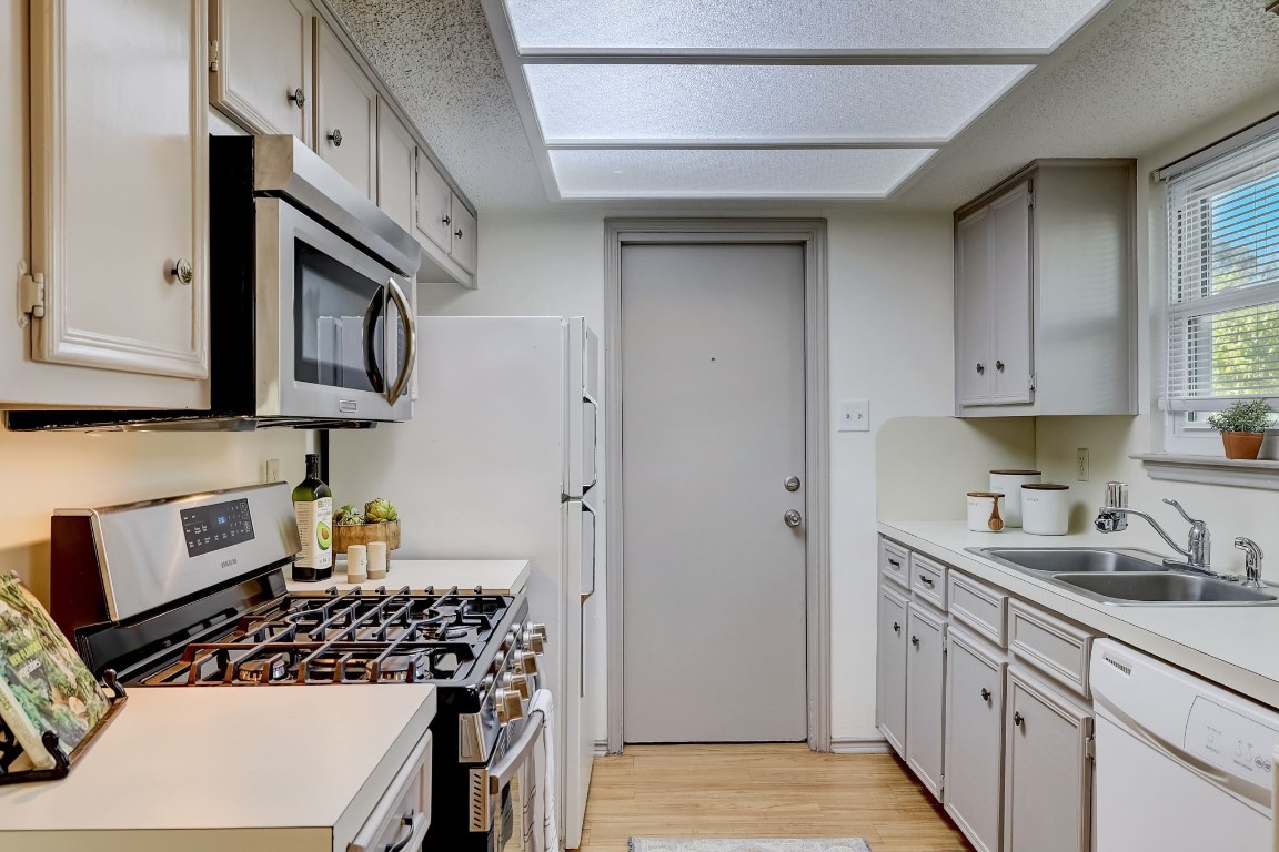 1709 Goodson Lane Round Rock, TX 78664 - Photo 11 of 37 a kitchen with stainless steel appliances granite countertop a stove and a refrigerator