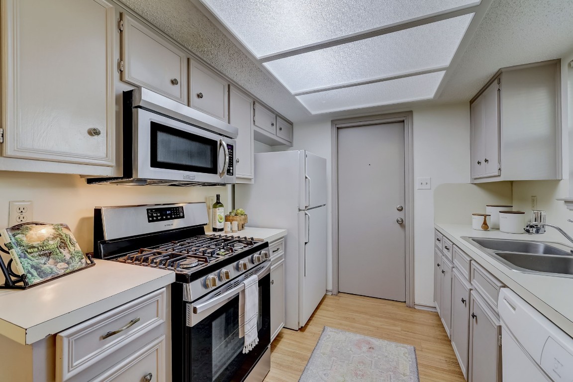 1709 Goodson Lane Round Rock, TX 78664 - Photo 13 of 37 a kitchen with sink a microwave and cabinets