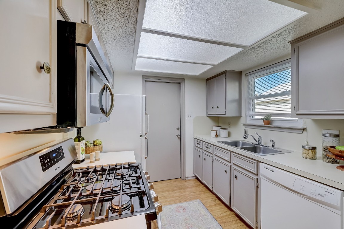1709 Goodson Lane Round Rock, TX 78664 - Photo 14 of 37 a kitchen with a stove a sink and a refrigerator