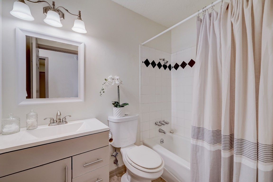 1709 Goodson Lane Round Rock, TX 78664 - Photo 16 of 37 a bathroom with a sink a toilet and shower curtain