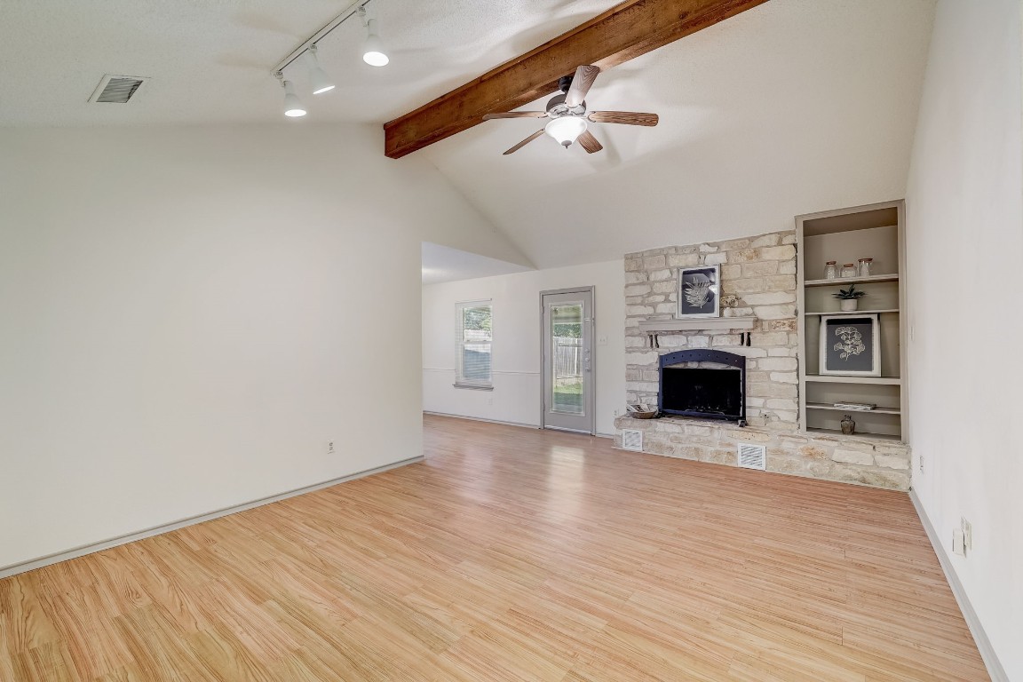 1709 Goodson Lane Round Rock, TX 78664 - Photo 2 of 37 a view of empty room with wooden floor and fireplace