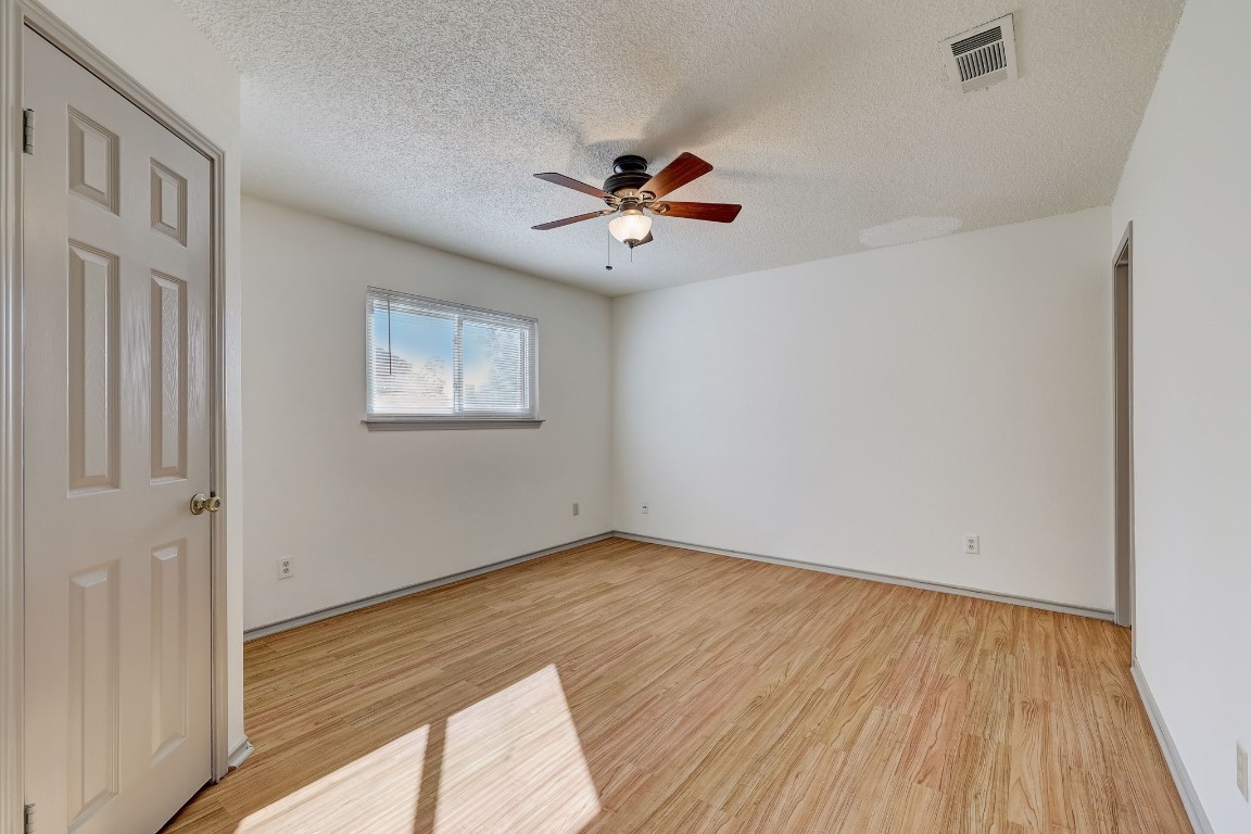 1709 Goodson Lane Round Rock, TX 78664 - Photo 21 of 37 a view of an empty room with wooden floor and a window