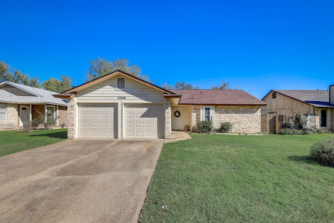 1709 Goodson Lane Round Rock, TX 78664 - Photo 36 of 37 a front view of a house with a yard and garage