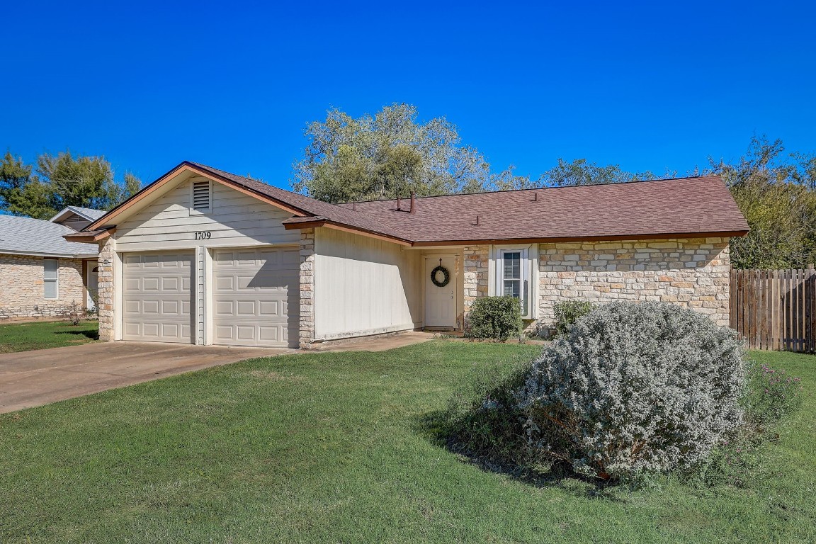 1709 Goodson Lane Round Rock, TX 78664 - Photo 4 of 37 a front view of a house with a yard