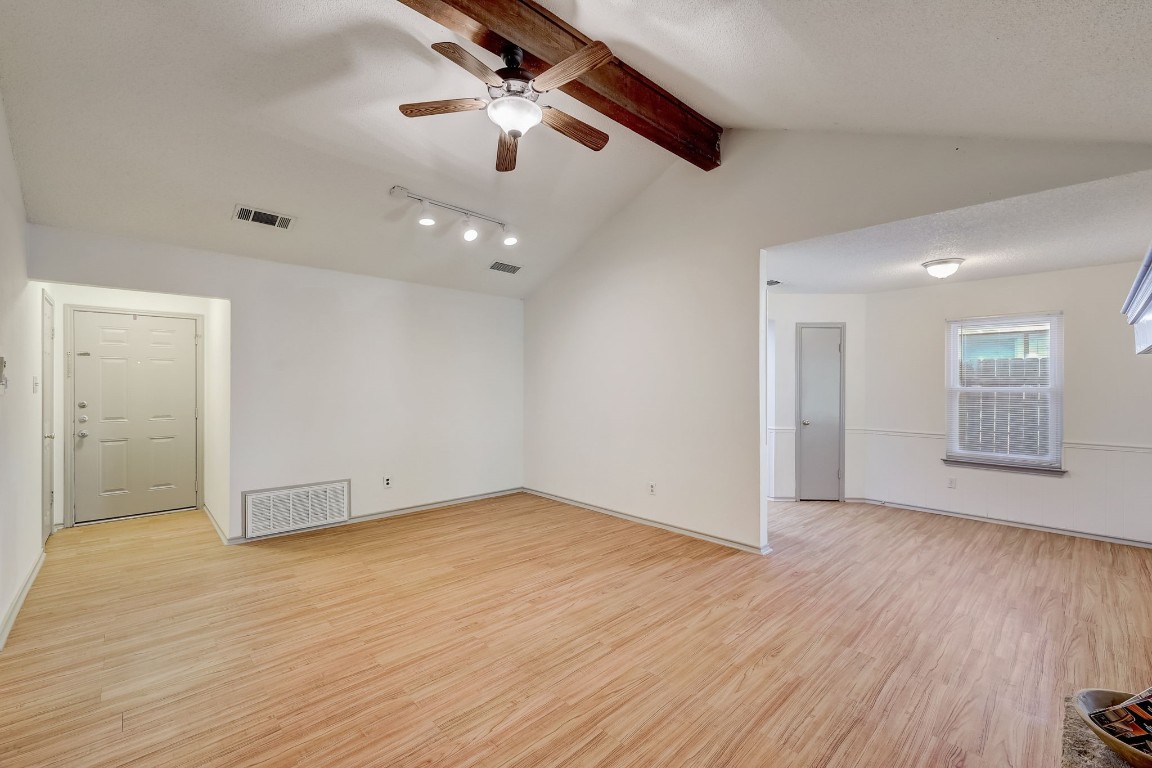 1709 Goodson Lane Round Rock, TX 78664 - Photo 6 of 37 an empty room with wooden floor chandelier fan and windows