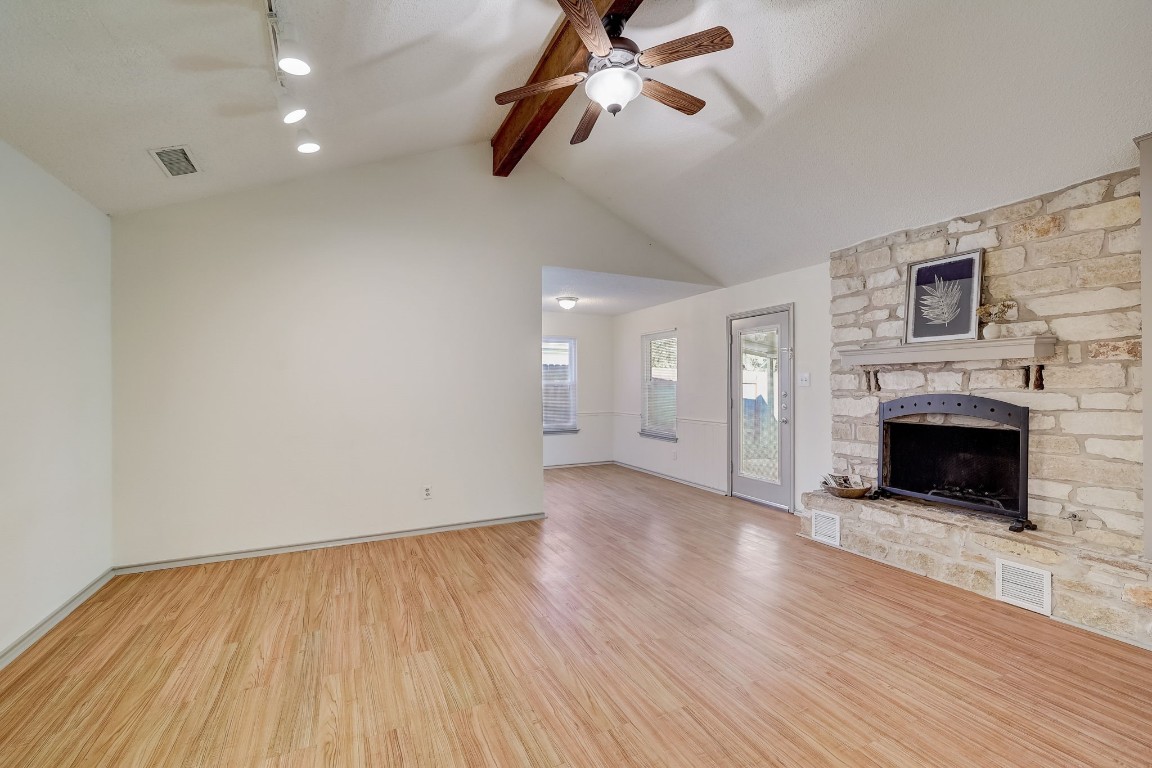 1709 Goodson Lane Round Rock, TX 78664 - Photo 8 of 37 wooden floor in an empty room with a fireplace