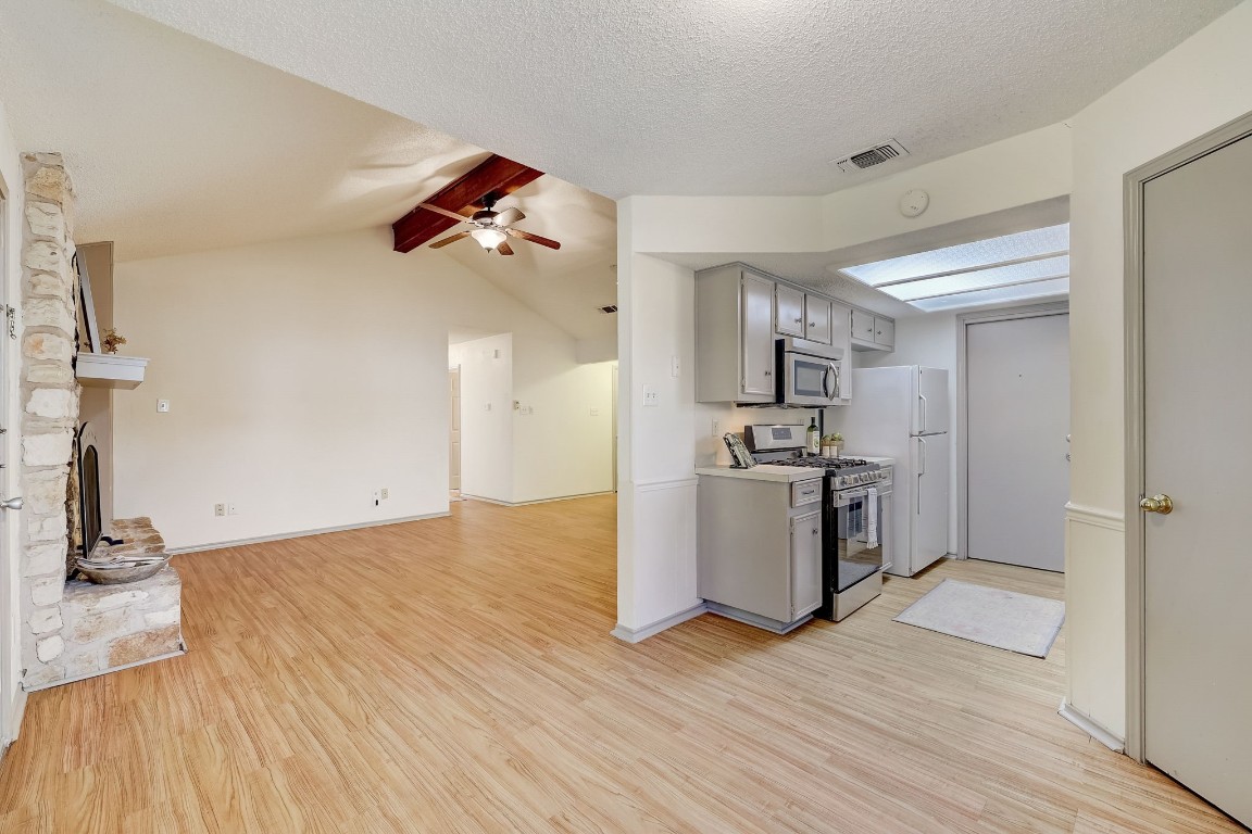 1709 Goodson Lane Round Rock, TX 78664 - Photo 10 of 37 a view of a kitchen with wooden floor and a sink