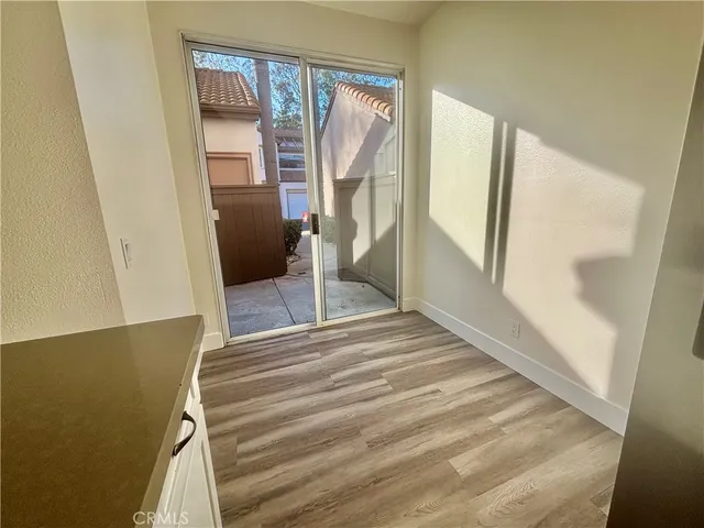 a view of a room with wooden floor and stairs