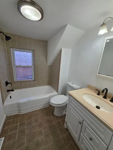 a bathroom with a sink a toilet and bathtub