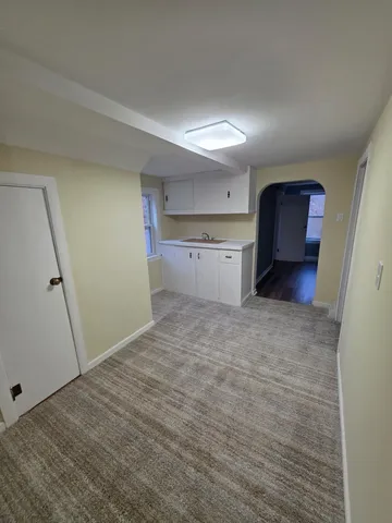 a view of a kitchen with a sink and cabinets