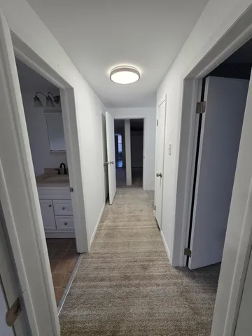 a view of hallway with stairs and a closet