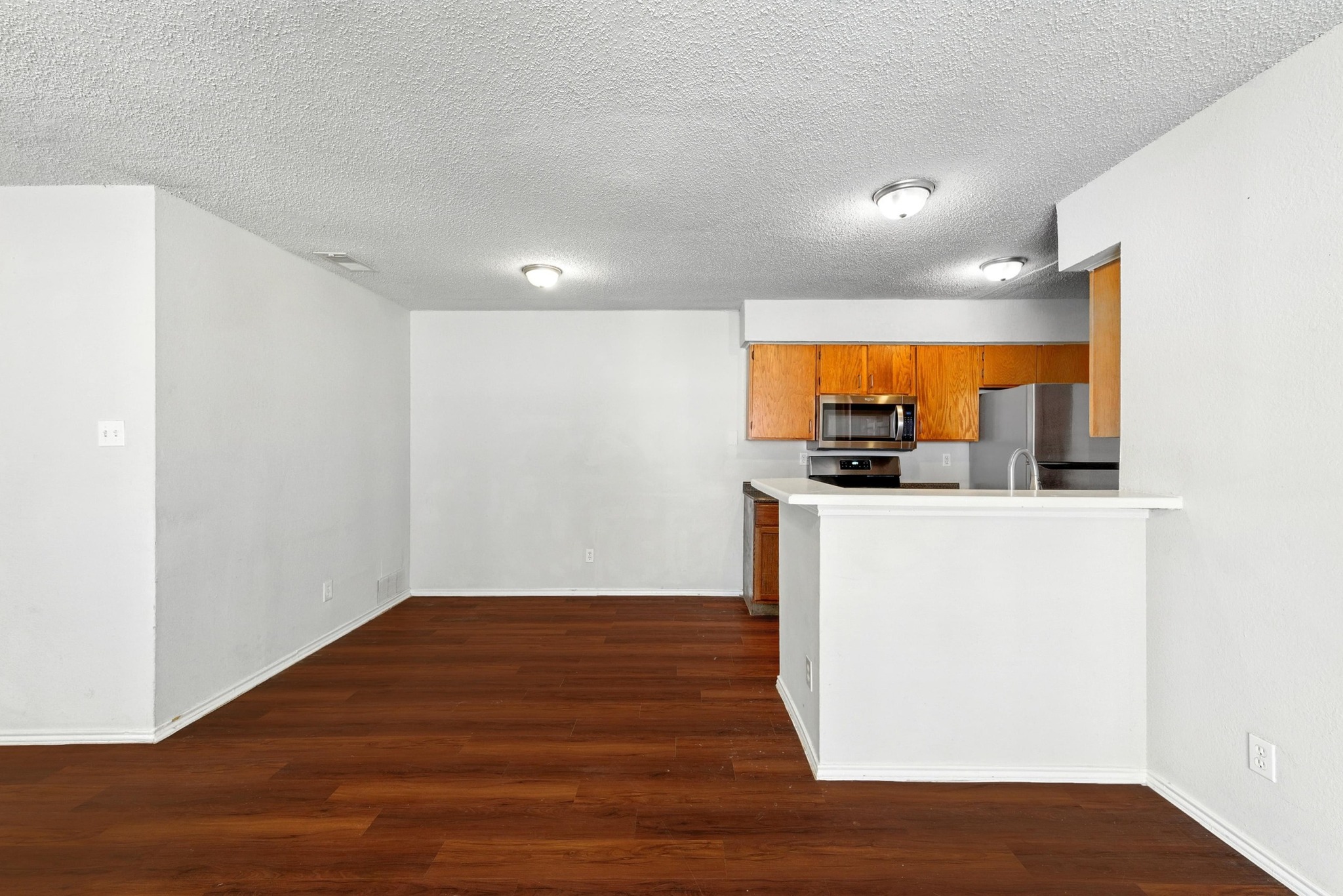 5707 Spring Meadow Road Austin, TX 78744 - Photo 9 of 21 a view of kitchen with wooden floor