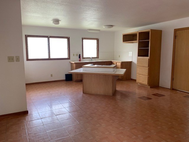 178 Eggerking Road Kapaa, HI 96746 - Photo 5 of 9 a view of a kitchen with windows and refrigerator