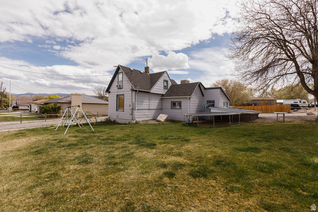 197 West 100 South Redmond, UT 84652 - Photo 6 of 41 Back of house featuring a chimney, a playground, and a shingled roof