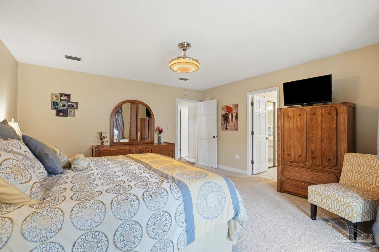 1437 Kings Road Cantonment, FL 32533 - Photo 24 of 67 a bedroom with a bed and a flat screen tv