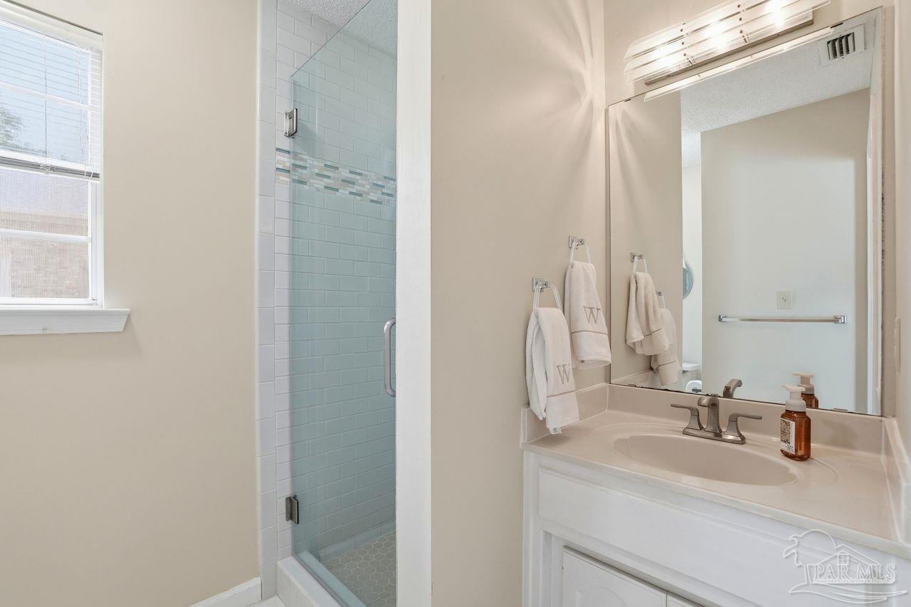 1437 Kings Road Cantonment, FL 32533 - Photo 33 of 67 a bathroom with a double vanity sink and a mirror
