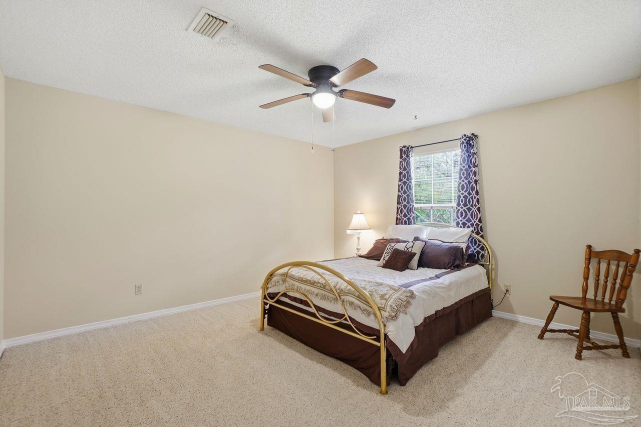 1437 Kings Road Cantonment, FL 32533 - Photo 39 of 67 a bedroom with a bed and a ceiling fan