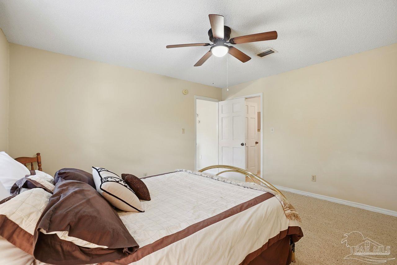 1437 Kings Road Cantonment, FL 32533 - Photo 40 of 67 a bedroom with a bed and a ceiling fan