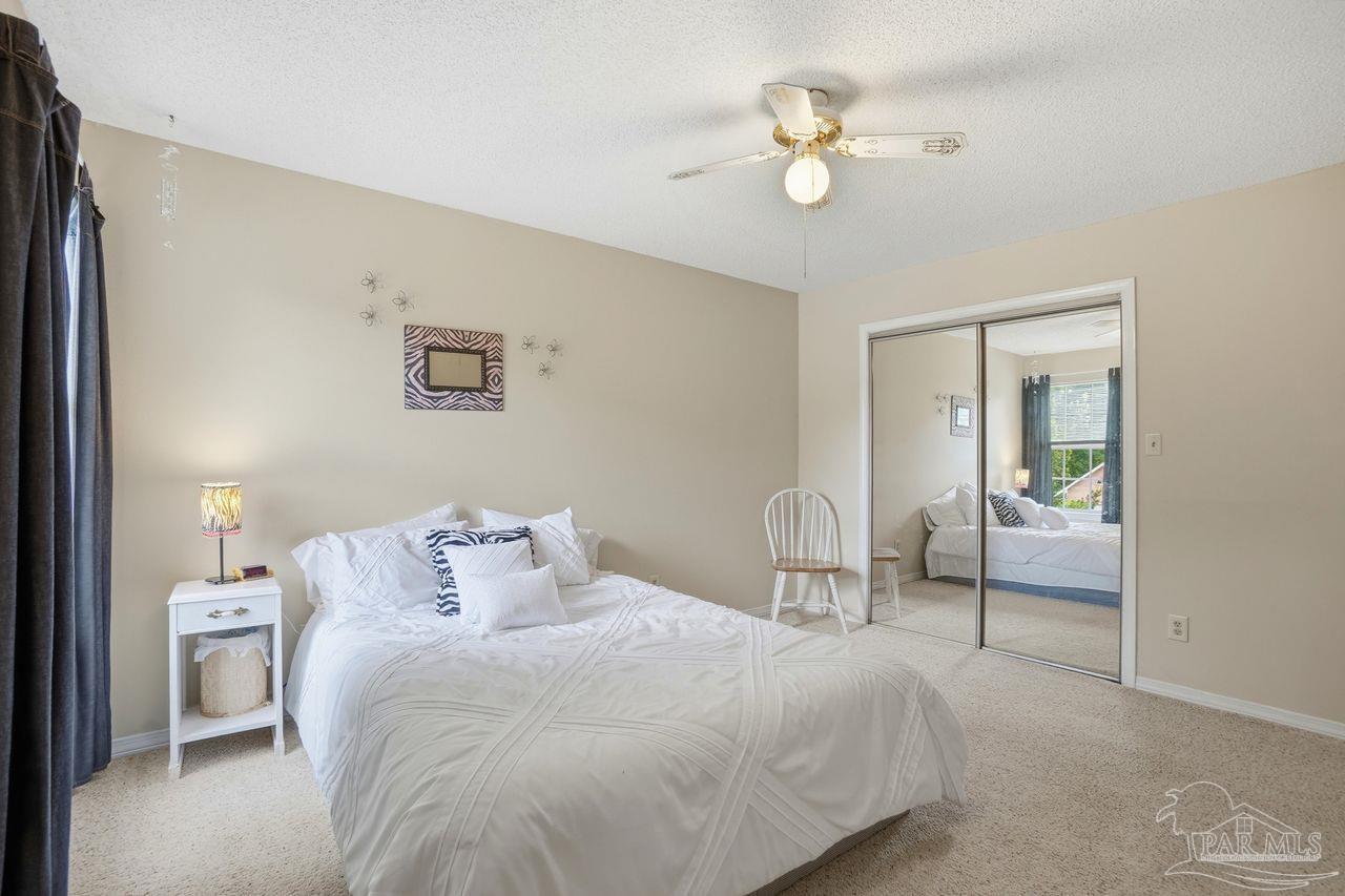 1437 Kings Road Cantonment, FL 32533 - Photo 45 of 67 a bedroom with a bed and a chandelier