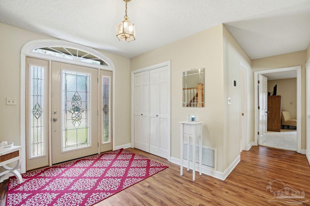 1437 Kings Road Cantonment, FL 32533 - Photo 5 of 67 a view of a bedroom with wooden floor and windows