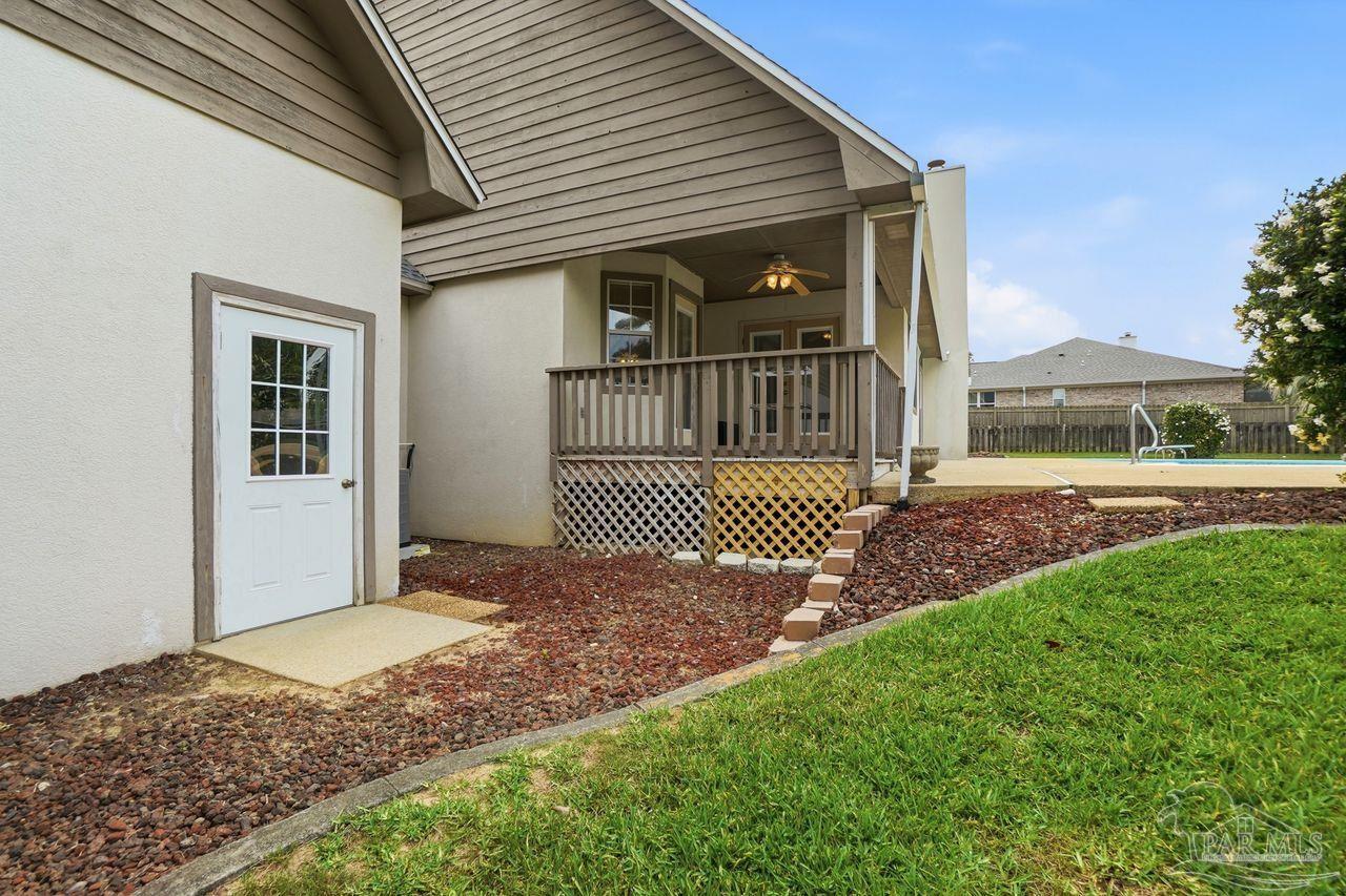 1437 Kings Road Cantonment, FL 32533 - Photo 56 of 67 a view of a brick house with a yard