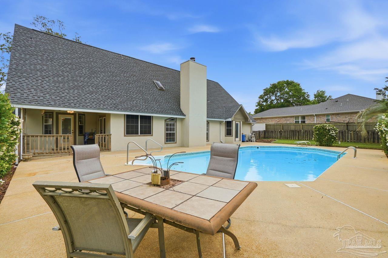 1437 Kings Road Cantonment, FL 32533 - Photo 60 of 67 a view of house with swimming pool outdoor seating and living room