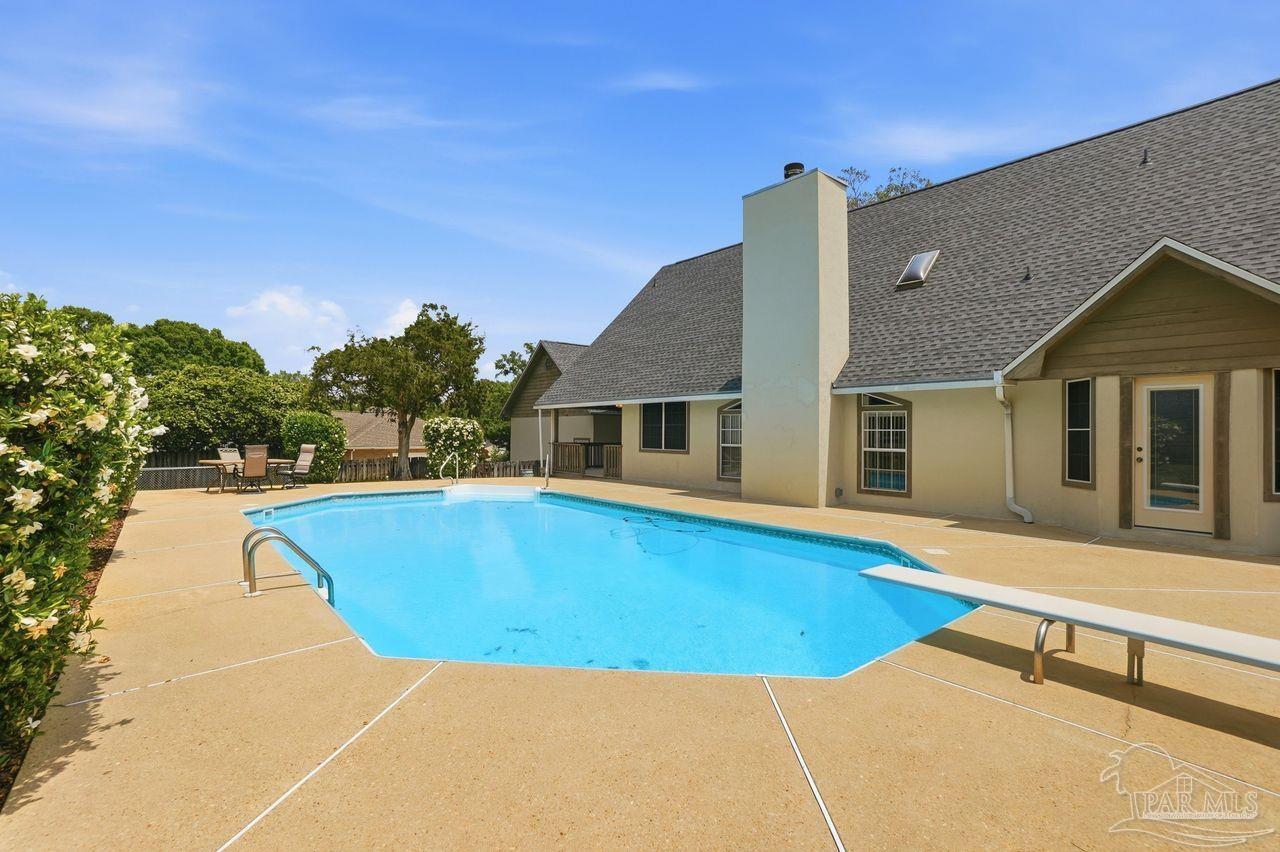 1437 Kings Road Cantonment, FL 32533 - Photo 61 of 67 a view of a house with pool and a yard
