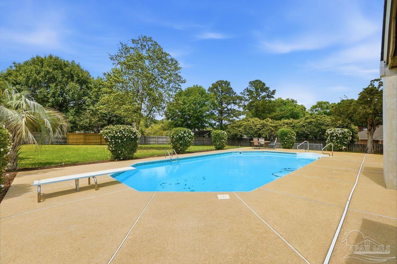 1437 Kings Road Cantonment, FL 32533 - Photo 63 of 67 a view of a swimming pool with an outdoor space and seating area