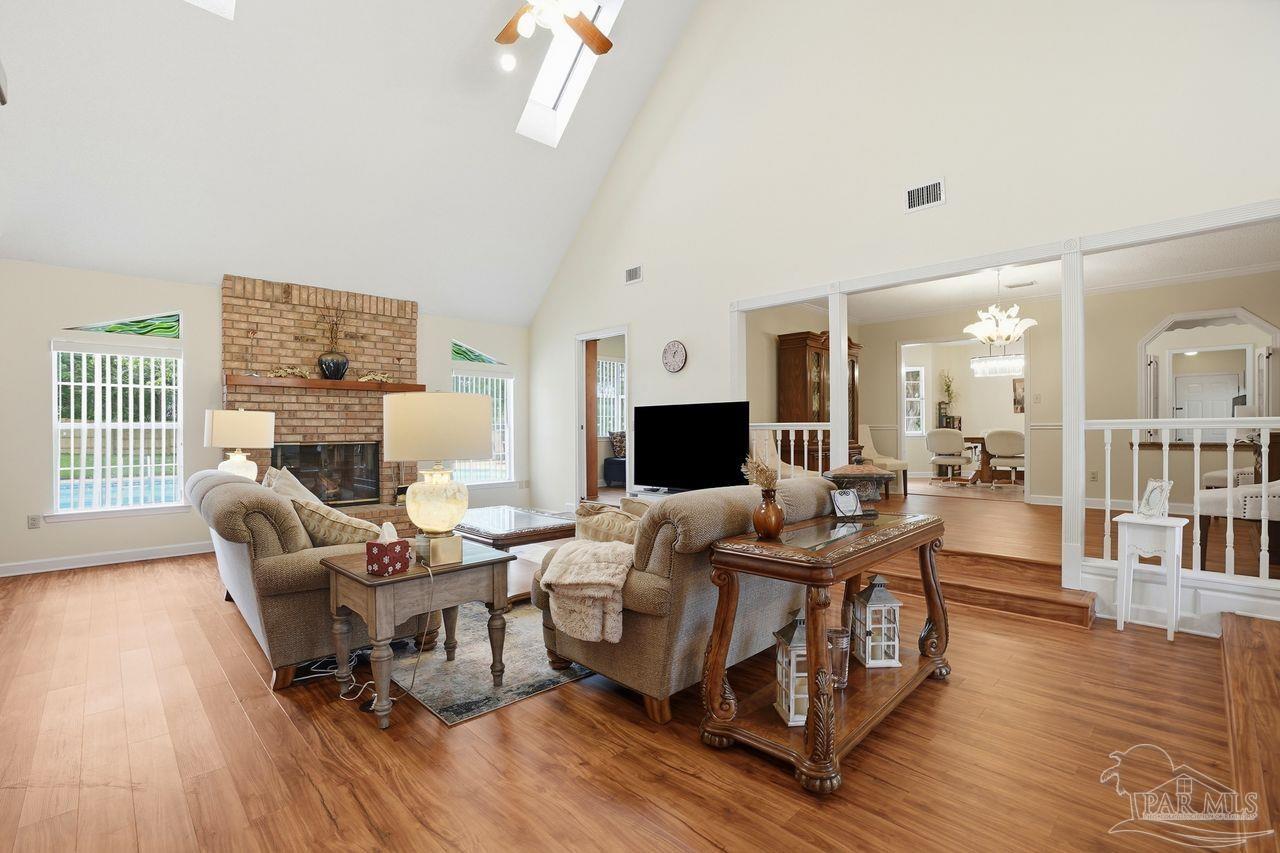 1437 Kings Road Cantonment, FL 32533 - Photo 7 of 67 a living room with fireplace furniture and a wooden floor