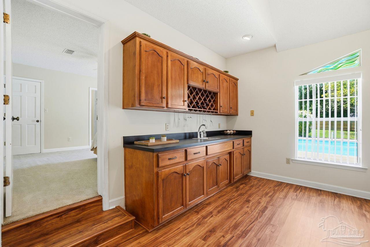 1437 Kings Road Cantonment, FL 32533 - Photo 10 of 67 a view of a kitchen with stainless steel appliances granite countertop a stove and a sink