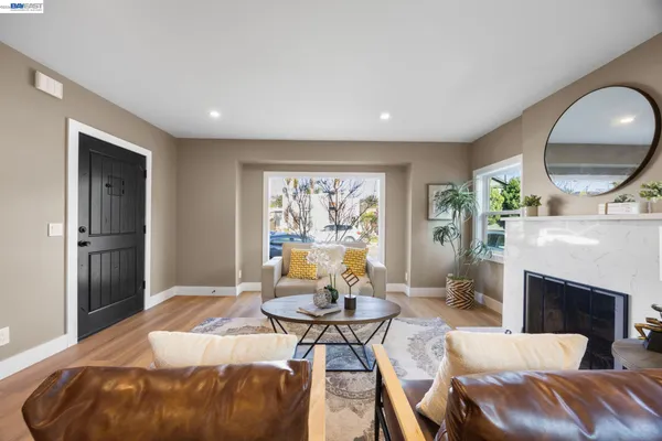 a living room with furniture a window and a fireplace