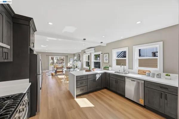a large kitchen with lots of counter top space and stainless steel appliances
