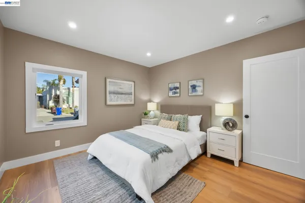 a bedroom with a large bed and a window