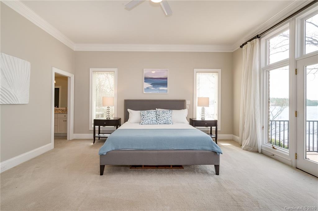 16133 North Point Road Huntersville, NC 28078 - Photo 13 of 42 a spacious bedroom with a bed and a large window