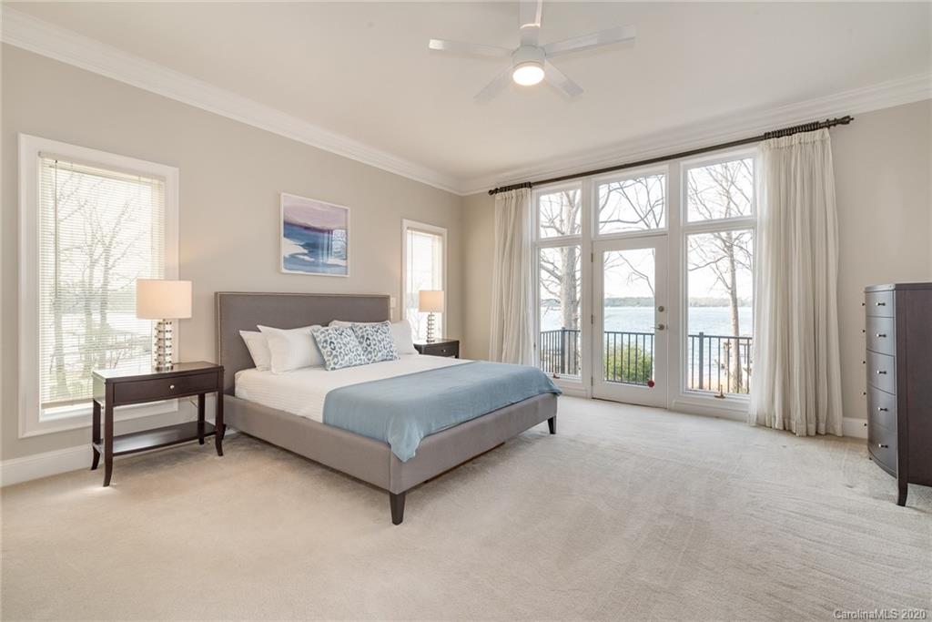 16133 North Point Road Huntersville, NC 28078 - Photo 14 of 42 a spacious bedroom with a large bed and a large window