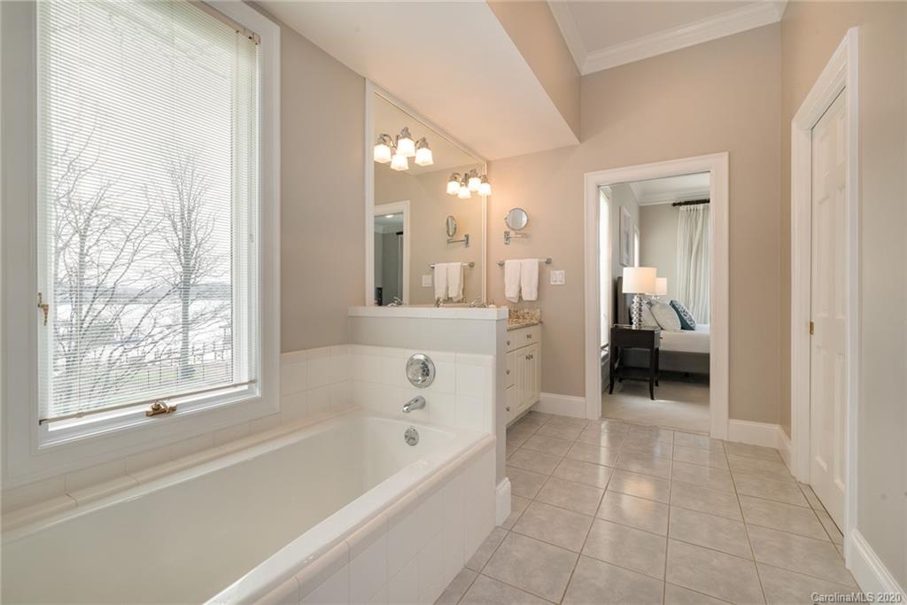 16133 North Point Road Huntersville, NC 28078 - Photo 16 of 42 a bathroom with a bathtub and a shower
