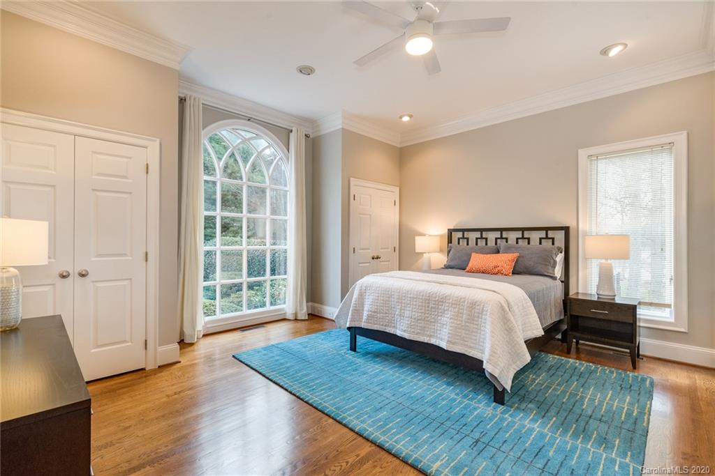 16133 North Point Road Huntersville, NC 28078 - Photo 17 of 42 a bedroom with a bed and wooden floor