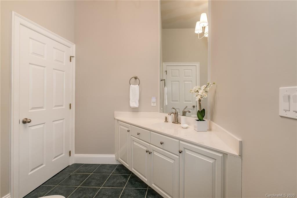 16133 North Point Road Huntersville, NC 28078 - Photo 19 of 42 a bathroom with a sink a vanity and a mirror