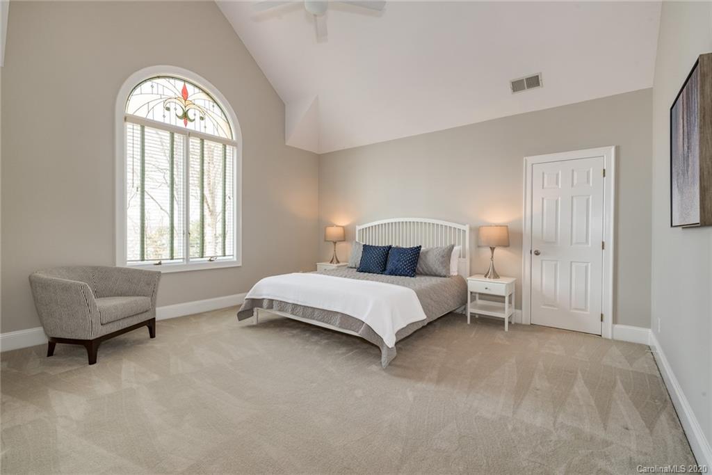 16133 North Point Road Huntersville, NC 28078 - Photo 21 of 42 a bedroom with a bed and a couch