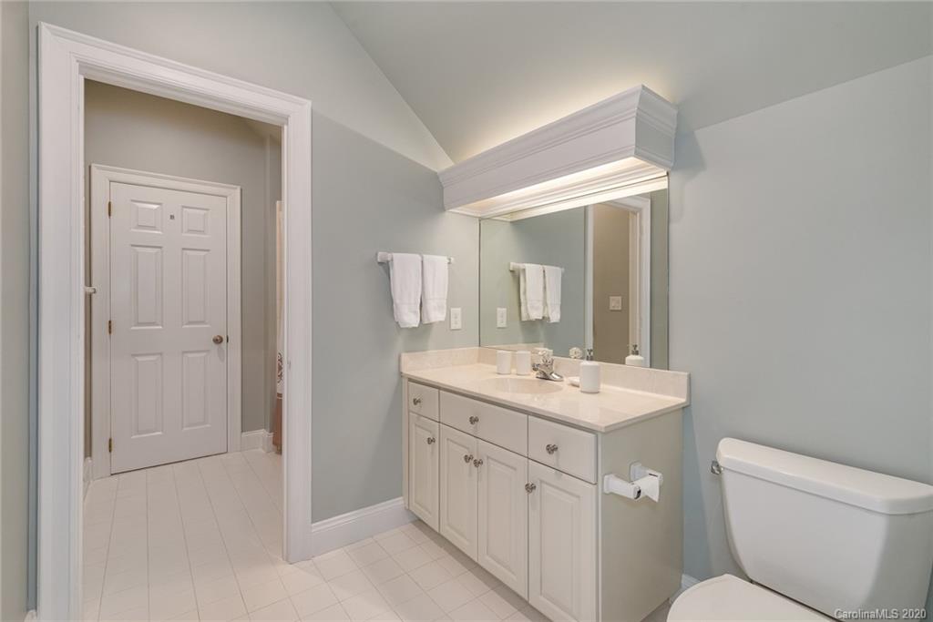 16133 North Point Road Huntersville, NC 28078 - Photo 22 of 42 a bathroom with a toilet sink and mirror