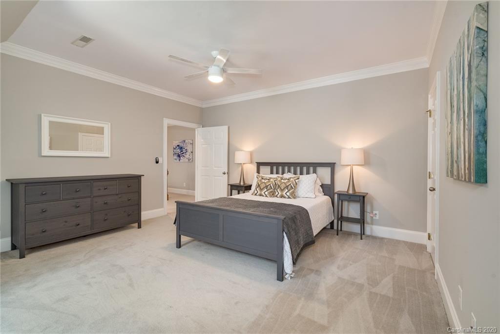 16133 North Point Road Huntersville, NC 28078 - Photo 23 of 42 a spacious bedroom with a bed and a cabinets
