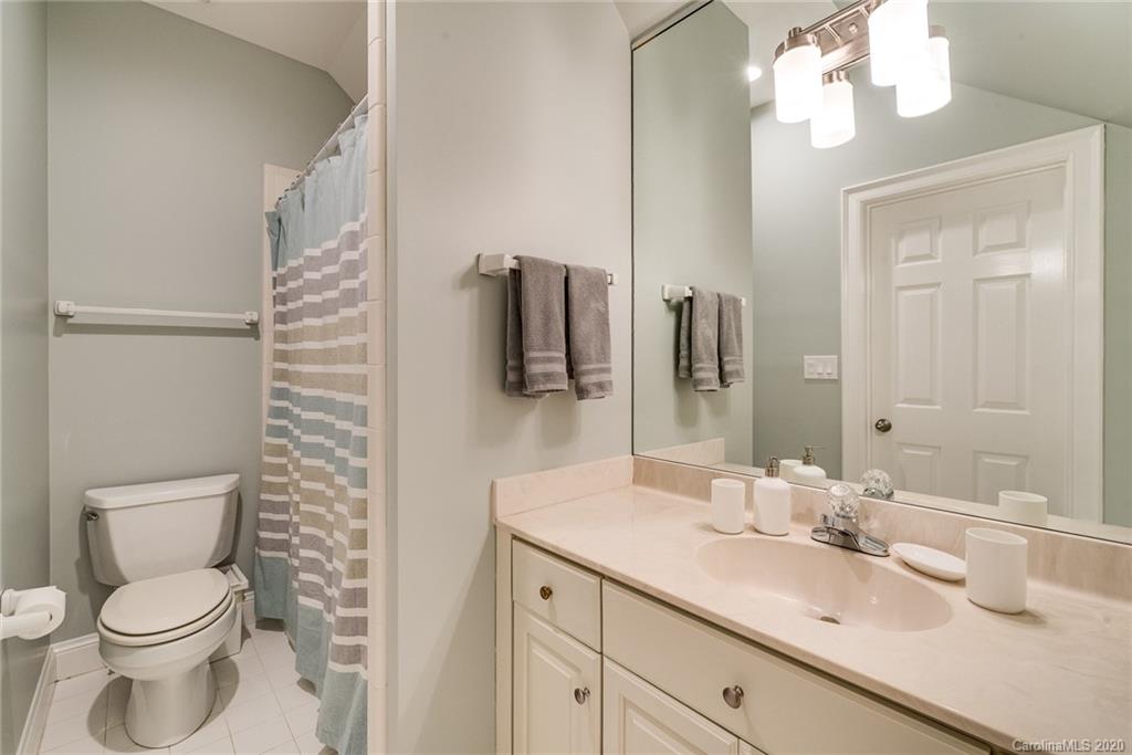 16133 North Point Road Huntersville, NC 28078 - Photo 25 of 42 a bathroom with a granite countertop toilet sink and mirror