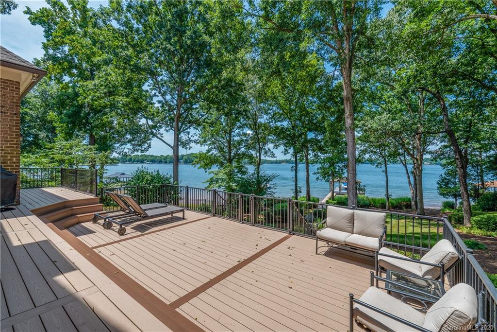 16133 North Point Road Huntersville, NC 28078 - Photo 28 of 42 a view of a patio with couches and a table and chairs with wooden floor and fence