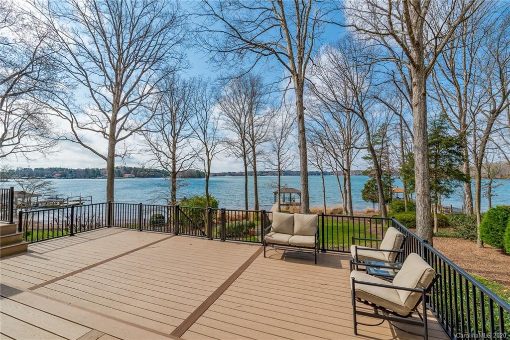 16133 North Point Road Huntersville, NC 28078 - Photo 34 of 42 a view of a deck with couches and large trees