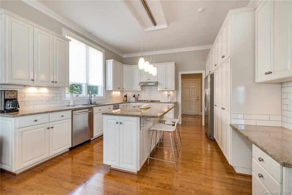 16133 North Point Road Huntersville, NC 28078 - Photo 8 of 42 a kitchen with stainless steel appliances granite countertop a sink stove refrigerator and cabinets