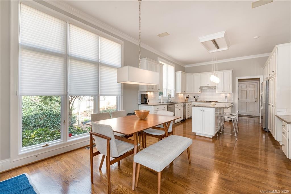 16133 North Point Road Huntersville, NC 28078 - Photo 10 of 42 a dining room with stainless steel appliances granite countertop furniture wooden floor and a kitchen view