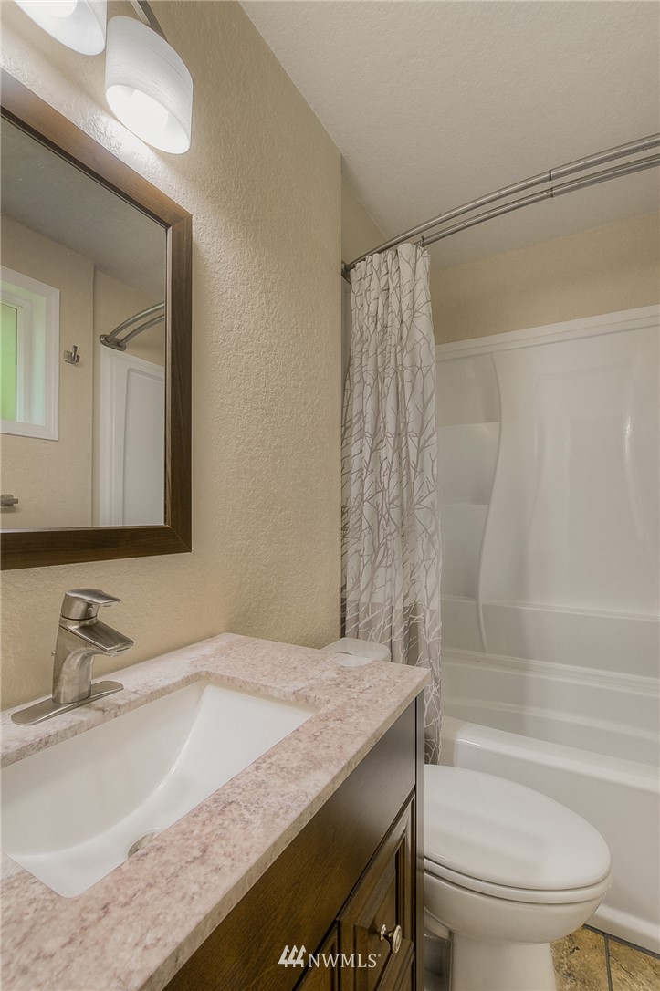 2111 Wells Court South Renton, WA 98055 - Photo 14 of 25 a bathroom with a granite countertop sink toilet and shower