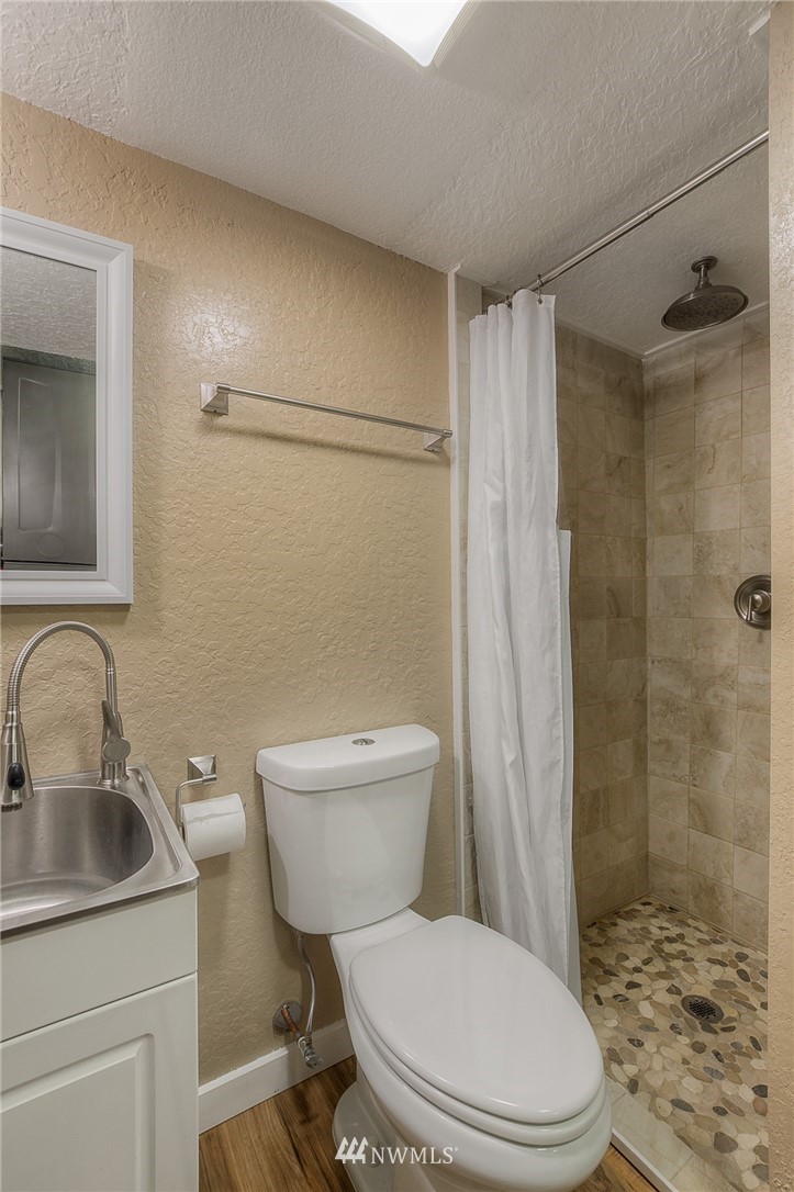 2111 Wells Court South Renton, WA 98055 - Photo 22 of 25 a white toilet sitting next to a bathroom sink