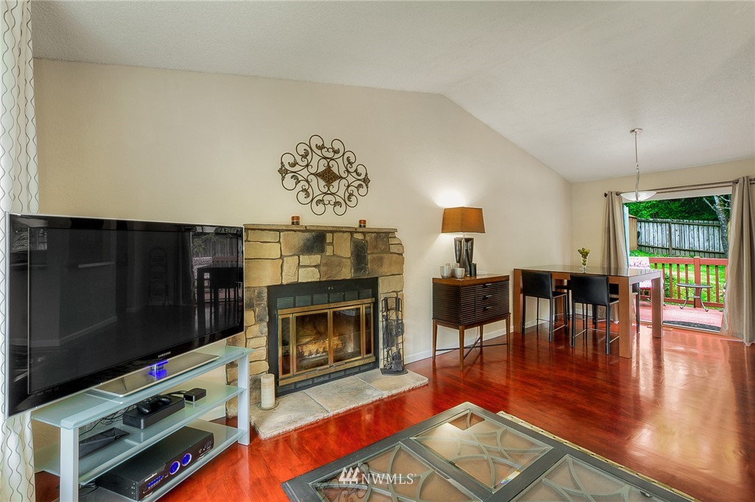 2111 Wells Court South Renton, WA 98055 - Photo 4 of 25 a living room with furniture a flat screen tv and a fireplace